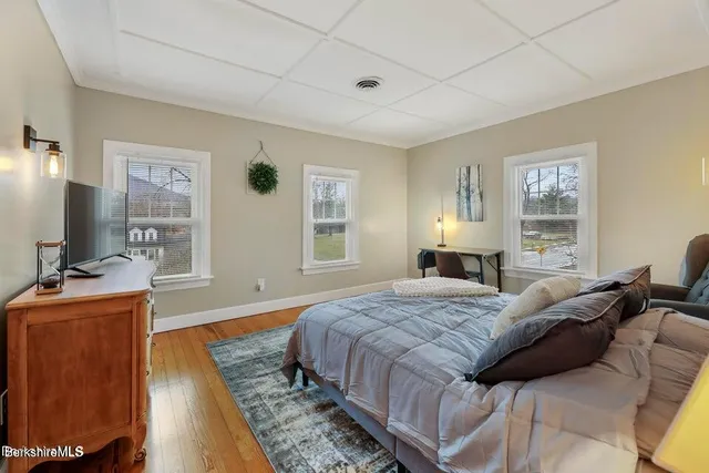 a bed room with furniture and a flat screen tv