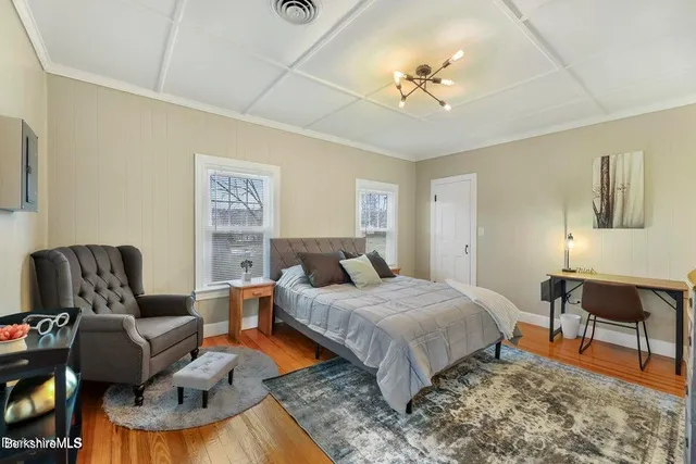 a bedroom with a bed and ceiling fan