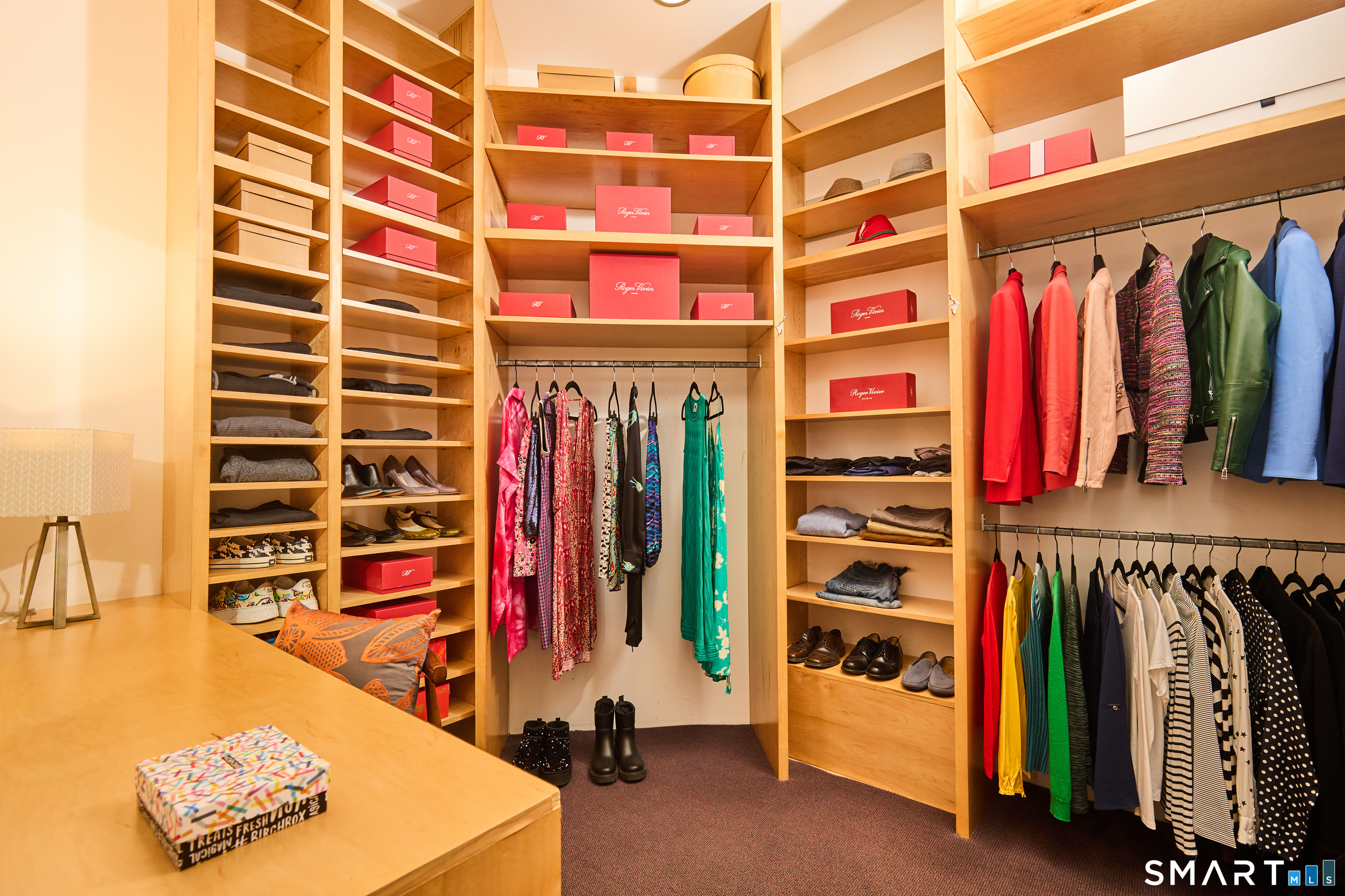a view of walk in closet with clothes and shoes