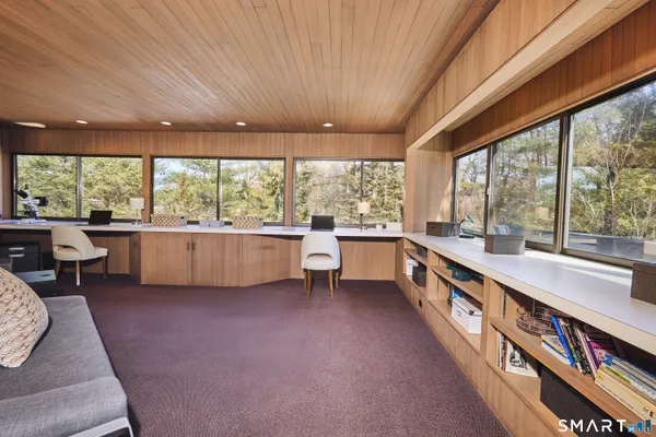 a living room with furniture and a floor to ceiling window
