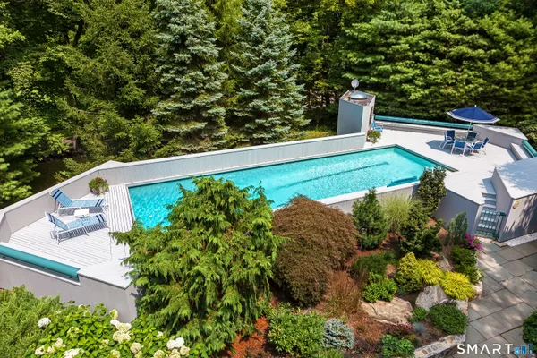 a view of swimming pool with lawn chairs and a lawn chairs