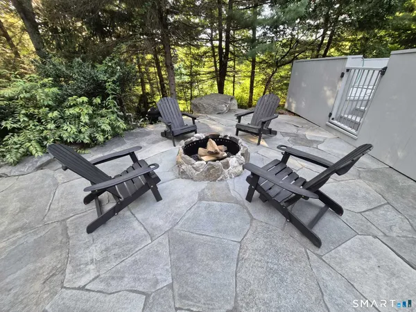 a view of a terrace with chairs and a fire pit