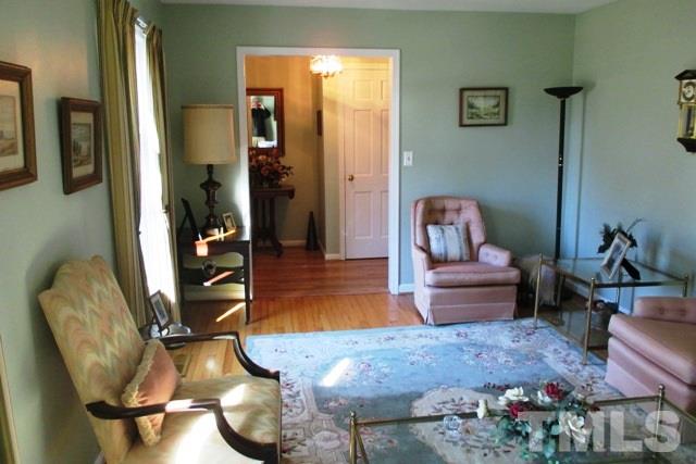 6600 King Lawrence Road Raleigh, NC 27607 - Photo 3 of 25 a room with furniture flowerpot and wooden floor