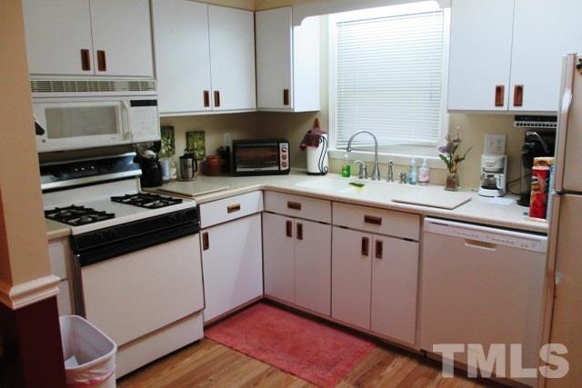 6600 King Lawrence Road Raleigh, NC 27607 - Photo 7 of 25 a kitchen with cabinets appliances and a sink
