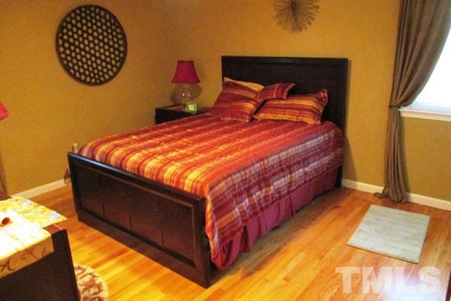 6600 King Lawrence Road Raleigh, NC 27607 - Photo 10 of 25 a bed sitting in a bedroom next to a window