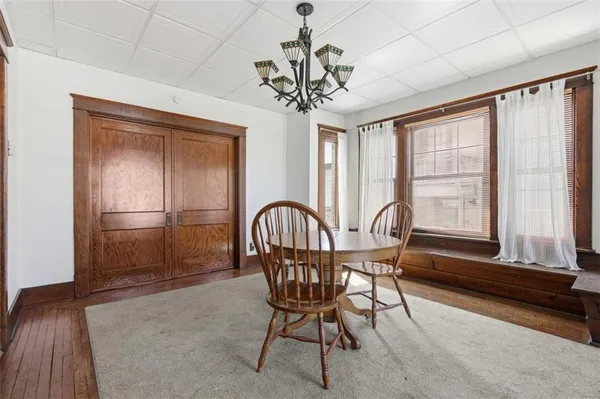 a view of a hallway with wooden floor and entryway