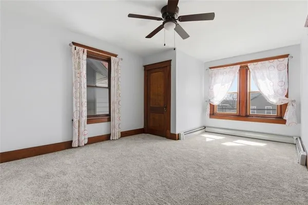 a room with gym equipment and wooden floor