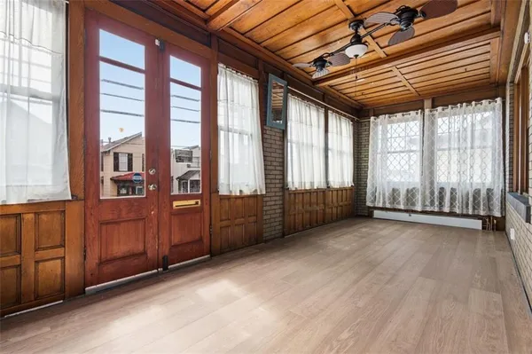 a view of a porch with wooden floor and stairs