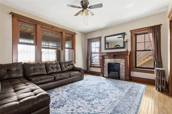 a living room with furniture and a wooden floor