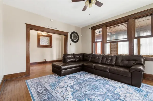 a view of a livingroom with furniture window and wooden floor