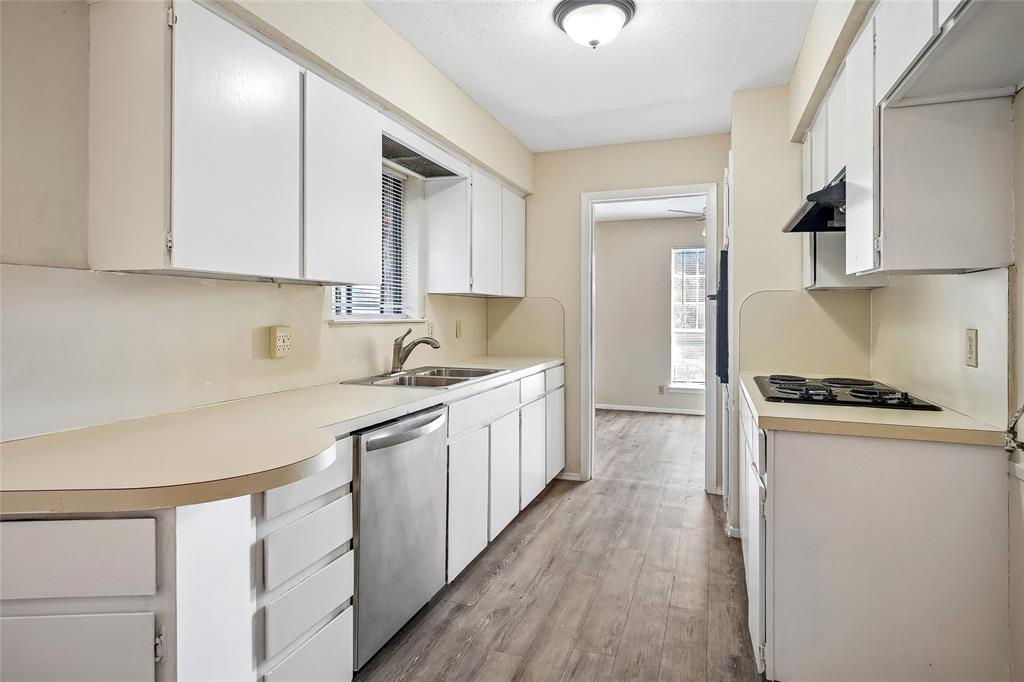 1903 North Floyd Road Richardson, TX 75080 - Photo 2 of 15 Nice kitchen with plenty of cabinet & countertop space with appliances including a stainless dishwasher, an electric cooktop and built-in oven.