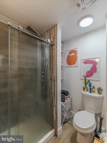 a white toilet sitting next to a bathroom sink