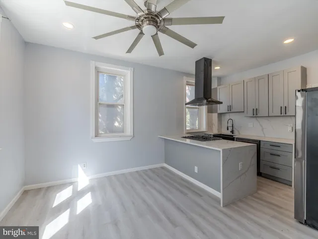 a kitchen with a stove a sink and a refrigerator
