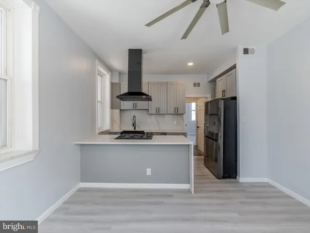 a view of a kitchen with a sink and a refrigerator
