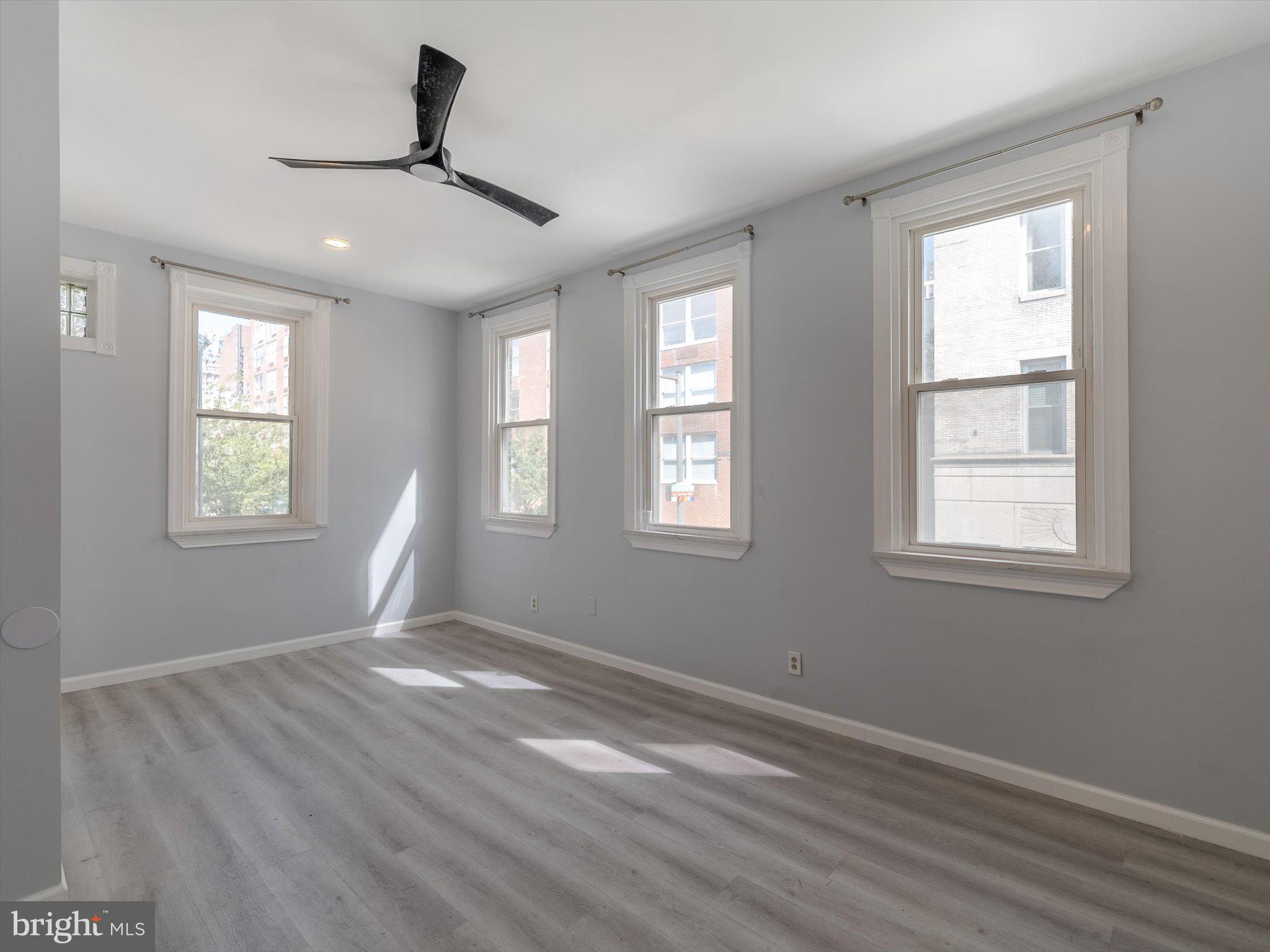 1108 Locust Street Philadelphia, PA 19107 - Photo 22 of 33 a view of an empty room with wooden floor and a window