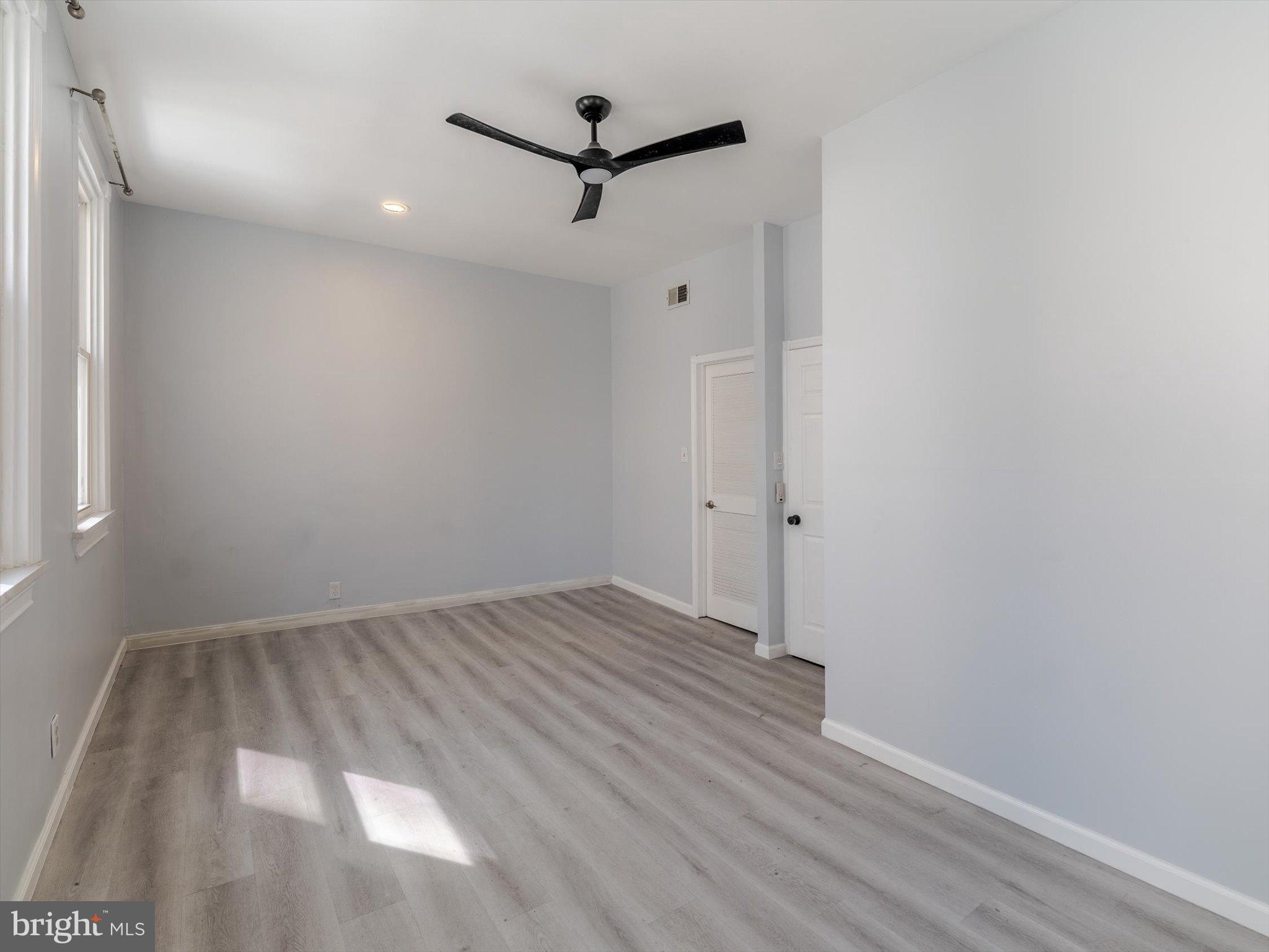 1108 Locust Street Philadelphia, PA 19107 - Photo 24 of 33 an empty room with wooden floor and a ceiling fan