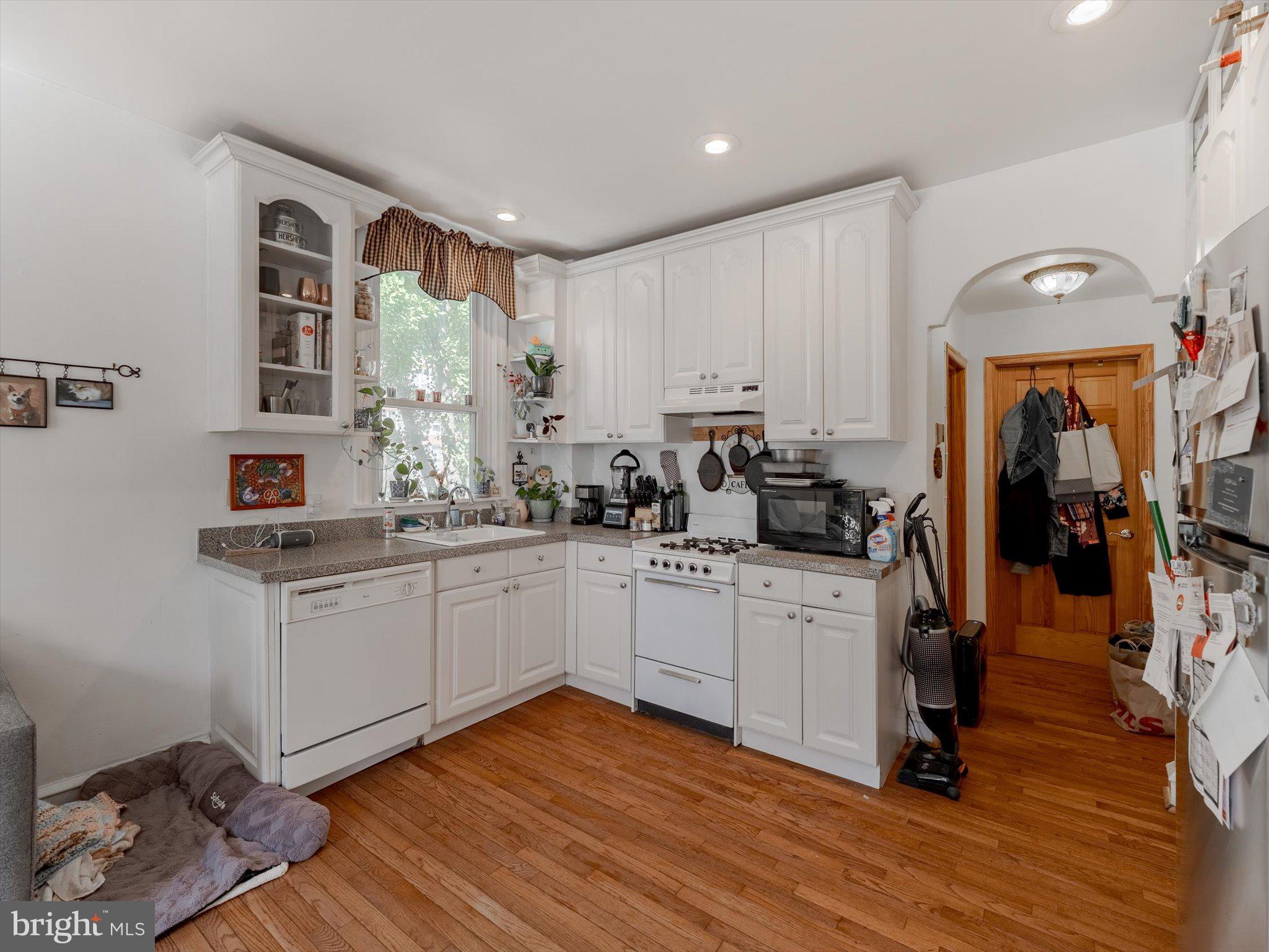 1108 Locust Street Philadelphia, PA 19107 - Photo 30 of 33 a kitchen with wooden floors and appliances