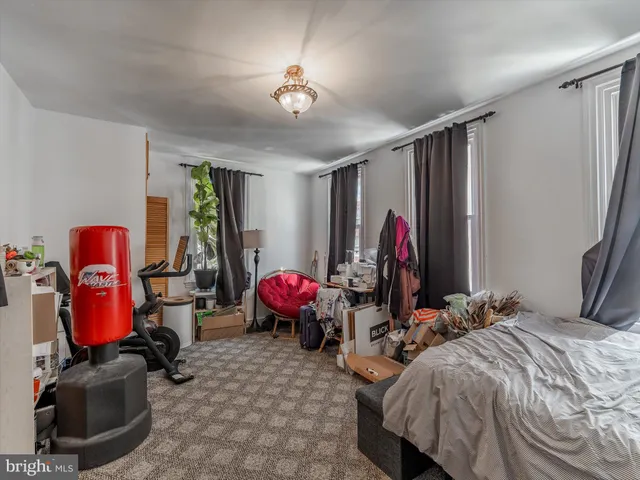 a bathroom with a sink a toilet a mirror and shower