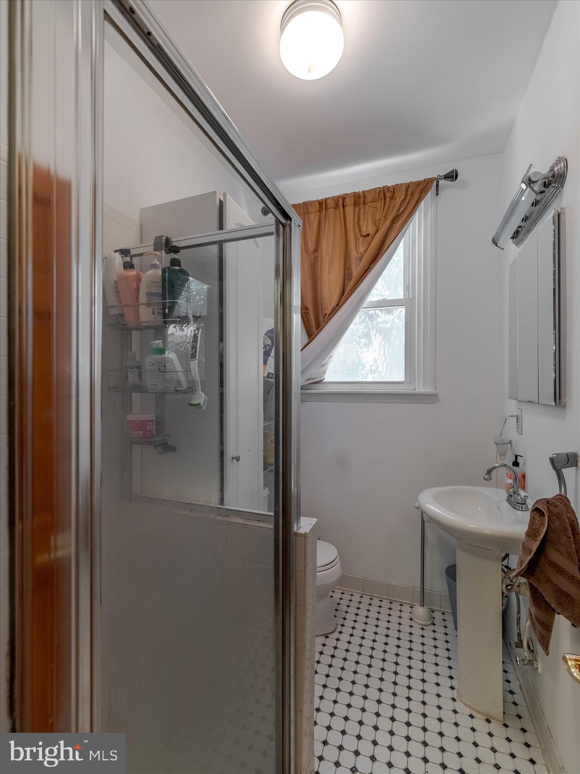 1108 Locust Street Philadelphia, PA 19107 - Photo 33 of 33 a bathroom with a sink a toilet a mirror and shower