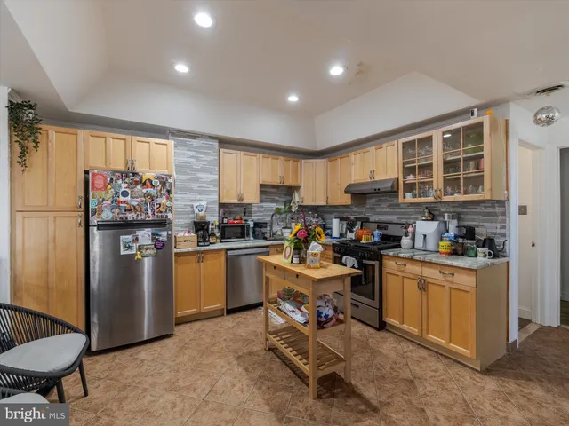 a kitchen with stainless steel appliances granite countertop a refrigerator stove microwave and sink