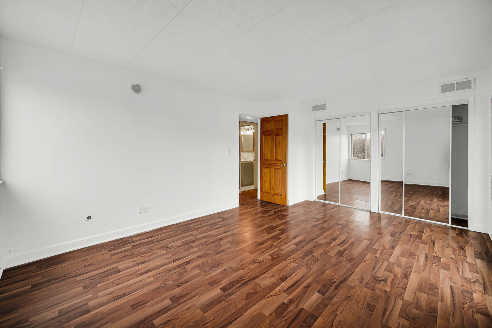 491 Timber Ridge Drive, Unit 101 Carol Stream, IL 60188 - Photo 11 of 19 wooden floor in an empty room