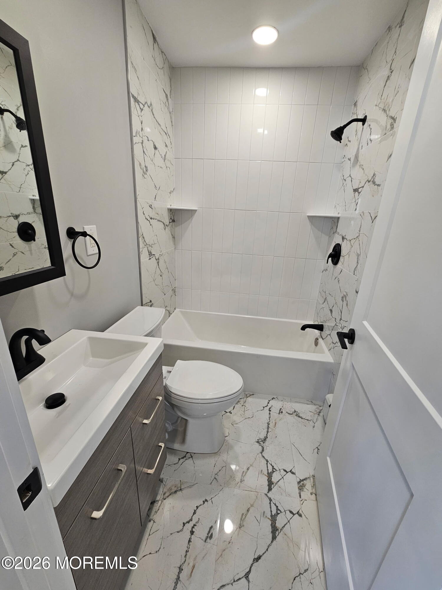 57 2nd Street Highlands, NJ 07732 - Photo 6 of 10 a bathroom with a sink a toilet and shower