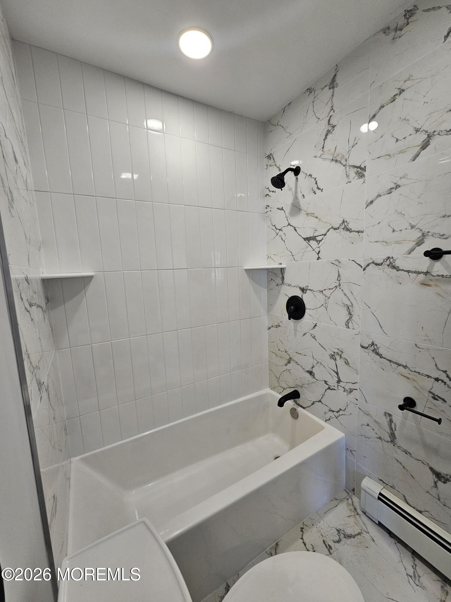 57 2nd Street Highlands, NJ 07732 - Photo 7 of 10 a bathroom with a bathtub and a toilet