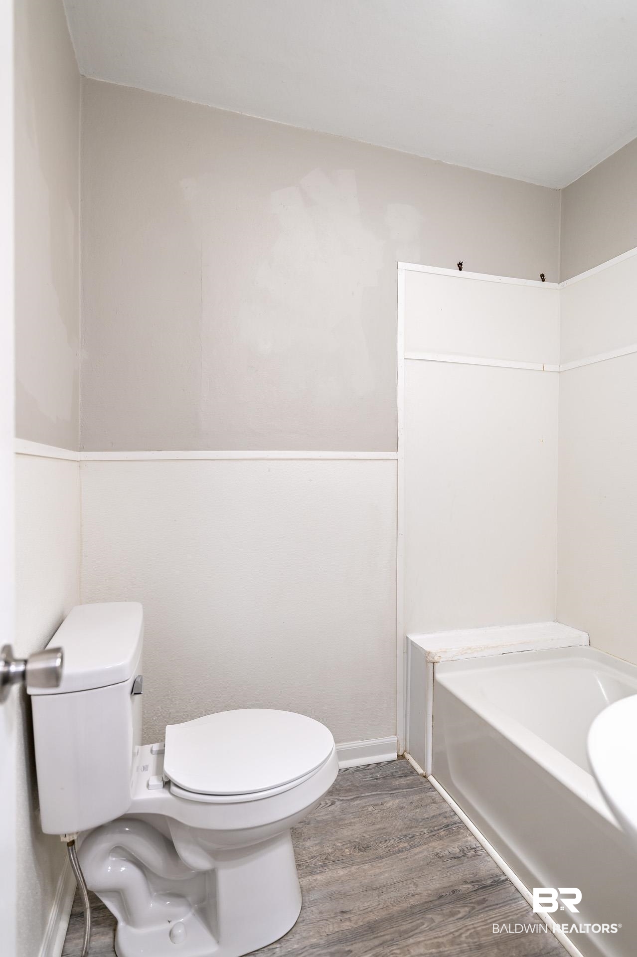 1869 Mott Drive West Mobile, AL 36617 - Photo 23 of 34 Full bath with toilet, baseboards, a tub to relax in, and wood finished floors