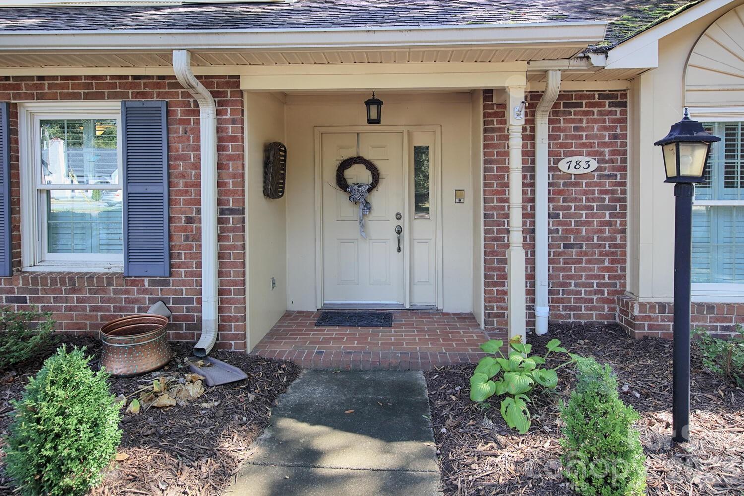 a front view of a house with garden