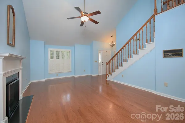 a view of empty room with fireplace and fan
