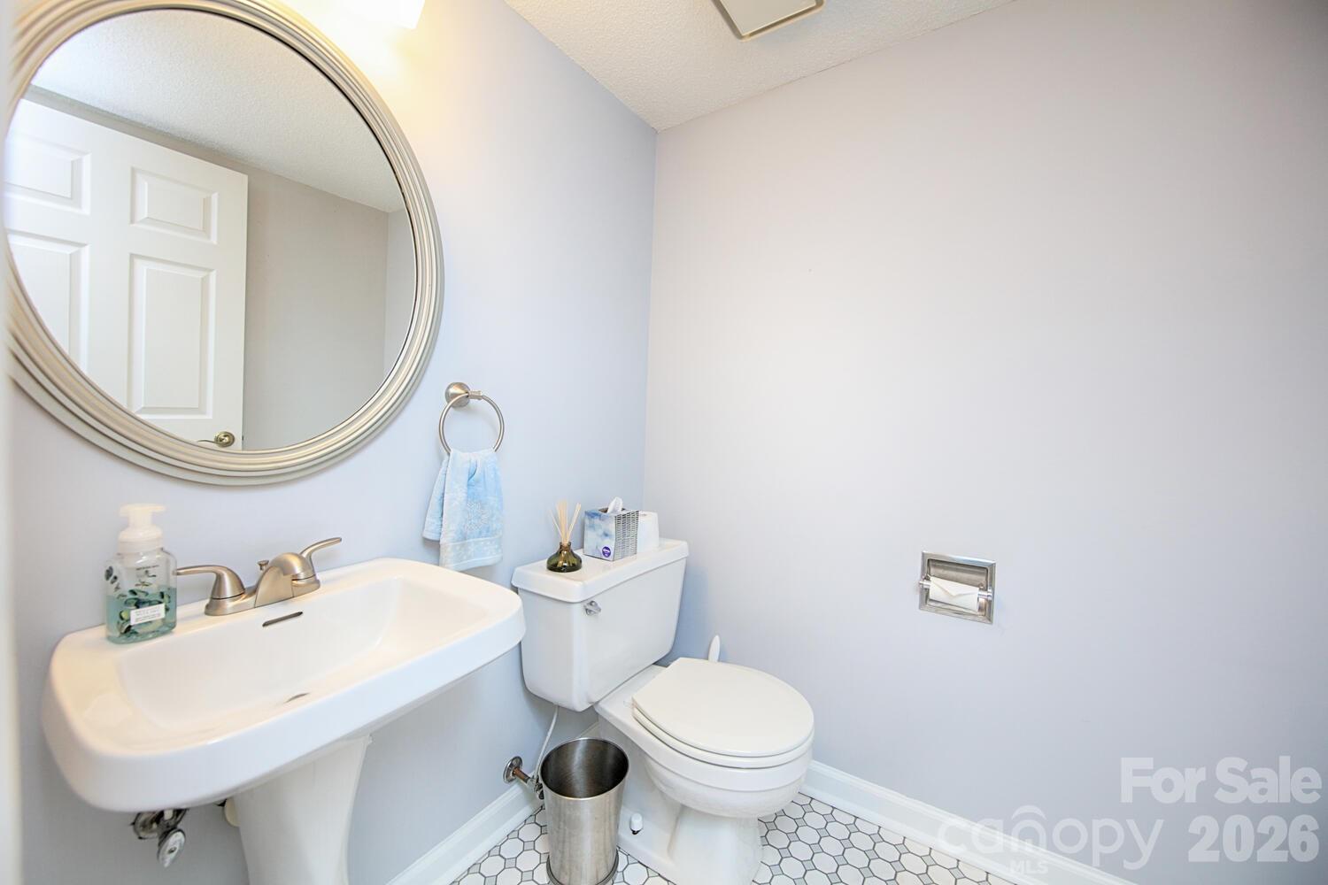 783 Union Street South Concord, NC 28025 - Photo 20 of 46 a bathroom with a sink a toilet and a mirror