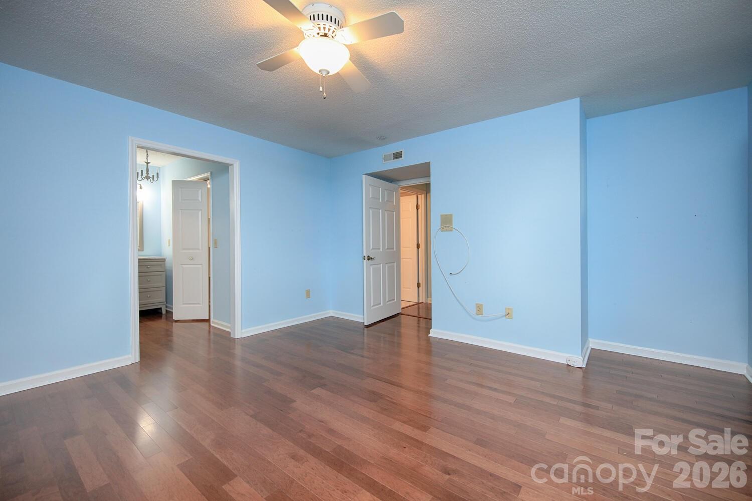 783 Union Street South Concord, NC 28025 - Photo 21 of 46 an empty room with wooden floor and a ceiling fan