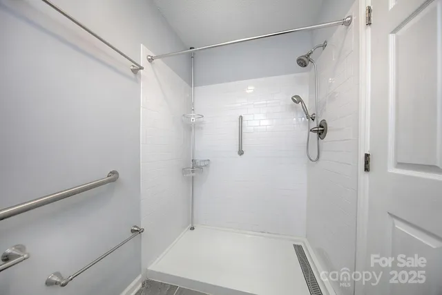 a bathroom with a shower and a shower