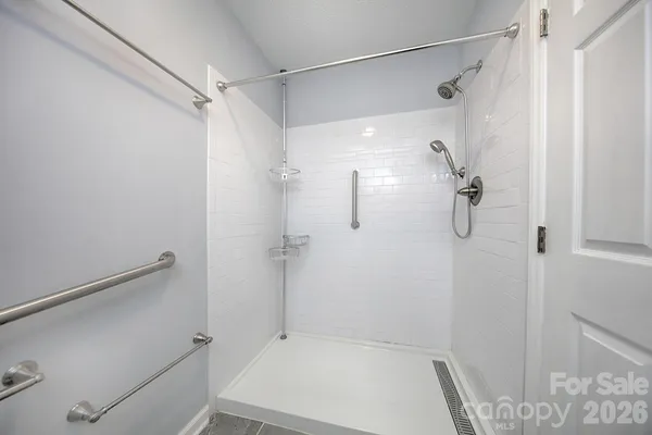 a bathroom with a toilet and a shower