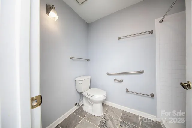 a bathroom with a toilet and a shower