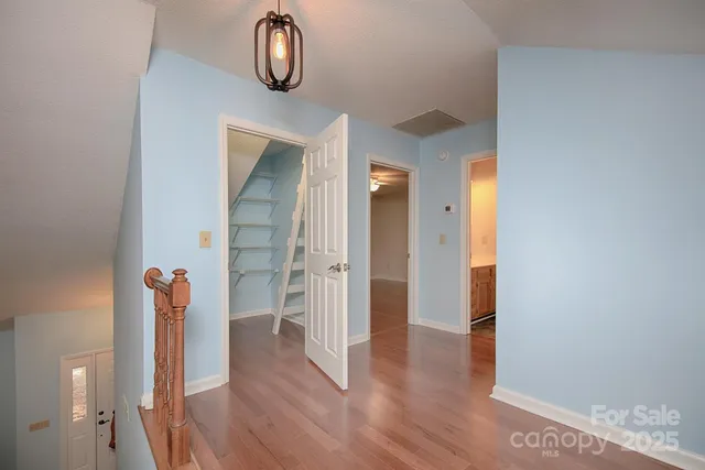 a view of walk in closet with empty racks