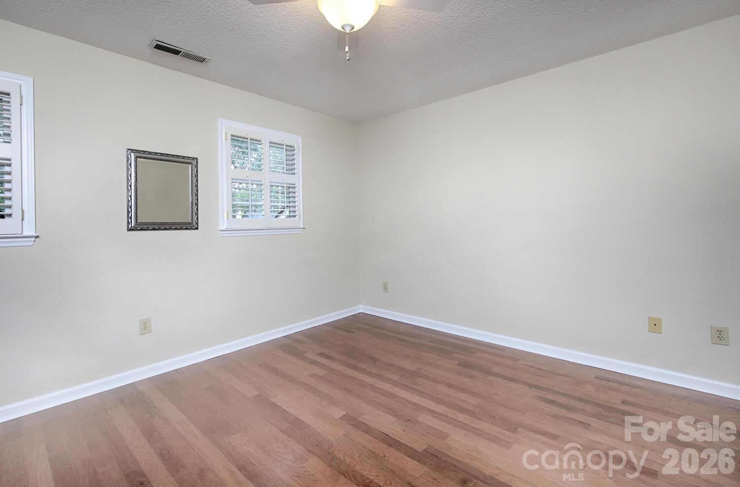 783 Union Street South Concord, NC 28025 - Photo 35 of 46 a view of an empty room with wooden floor and a window