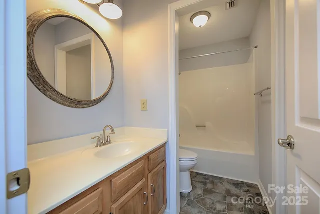 a view of a bathroom from a hallway