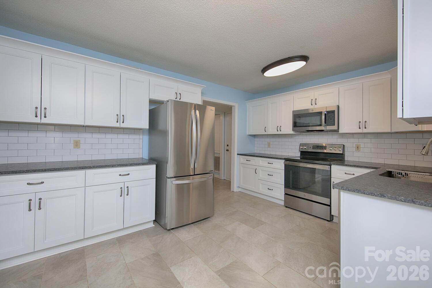 783 Union Street South Concord, NC 28025 - Photo 6 of 46 a kitchen with cabinets stainless steel appliances and a sink