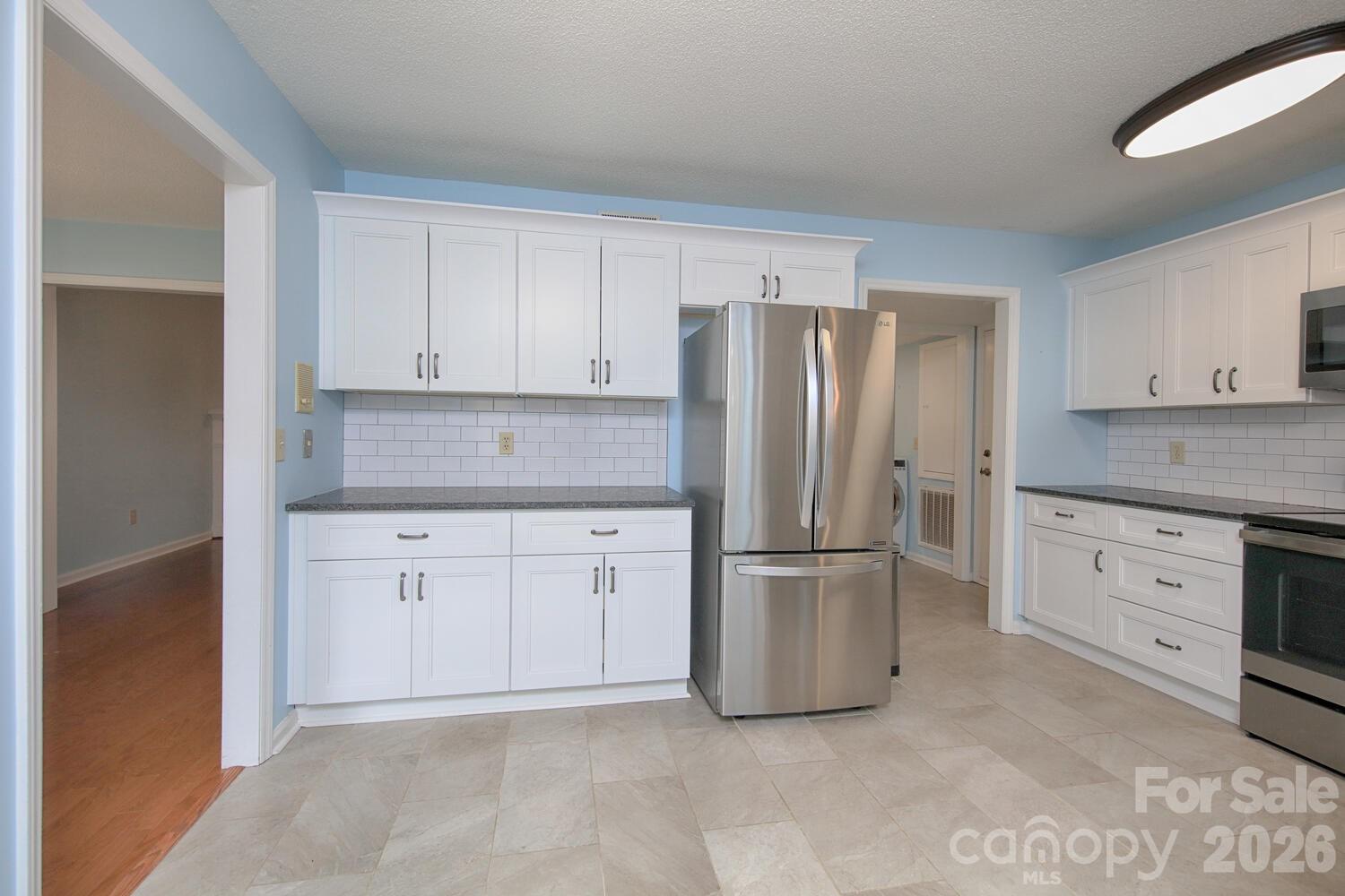 783 Union Street South Concord, NC 28025 - Photo 7 of 46 a kitchen with stainless steel appliances granite countertop a refrigerator sink and cabinets