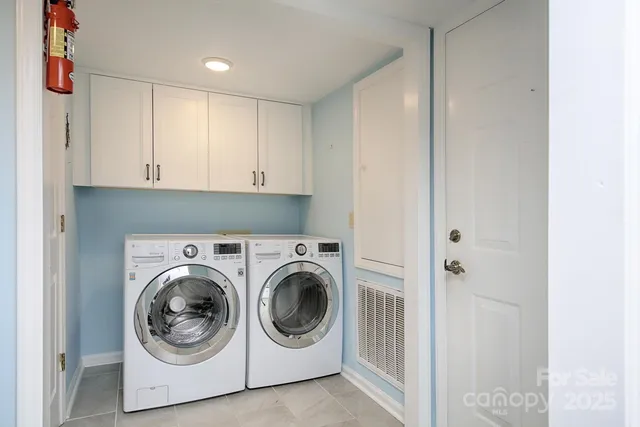 a utility room with washing machine and a view of bedroom