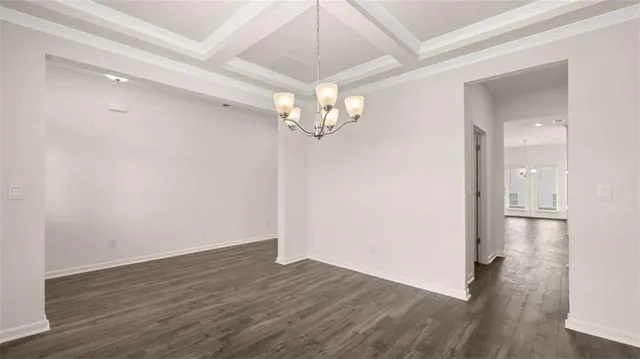 a kitchen with stainless steel appliances granite countertop a sink a microwave oven a refrigerator and white cabinets with wooden floor