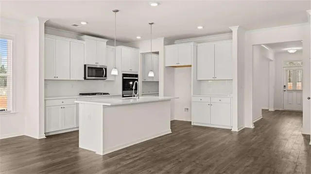 a kitchen with a stove oven and a sink