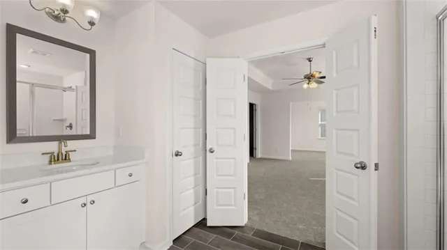 a view of an empty room with wooden floor and windows