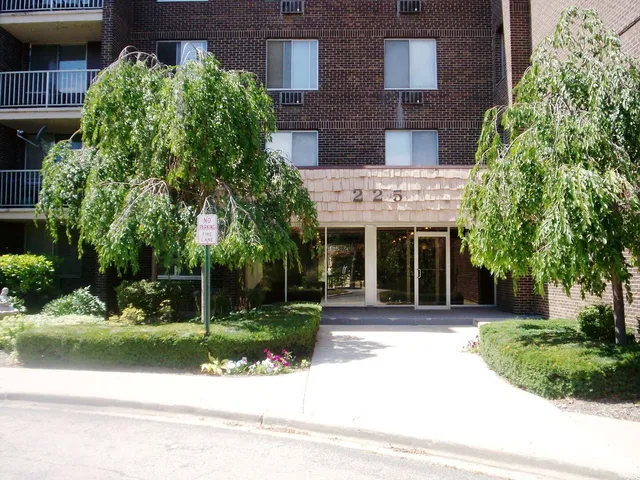 front view of a brick house with a yard