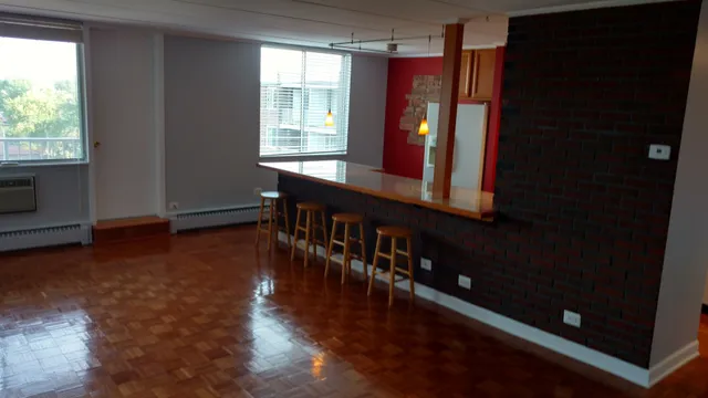 a view of a room with wooden floor and windows