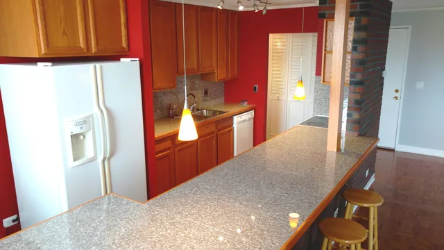 a kitchen with stainless steel appliances granite countertop a refrigerator