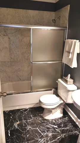 a bathroom with a toilet and a shower
