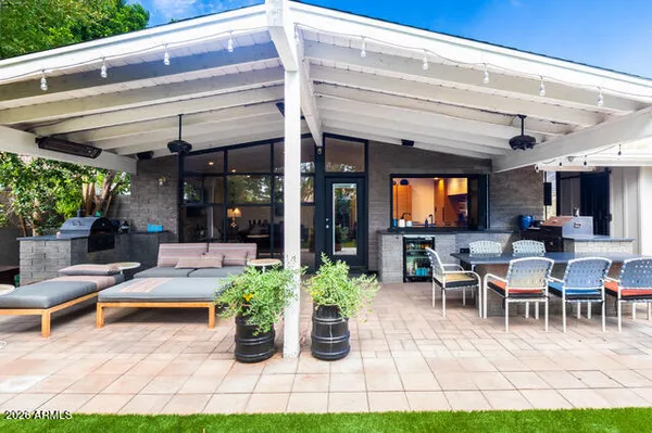 a view of a patio with dining table and chairs potted plants