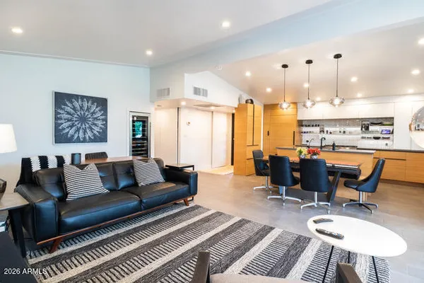 a living room with furniture and a chandelier